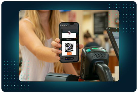 Customer presenting a QR code from their FaciliPay digital wallet to a scanner at a café counter to make a cashless payment.