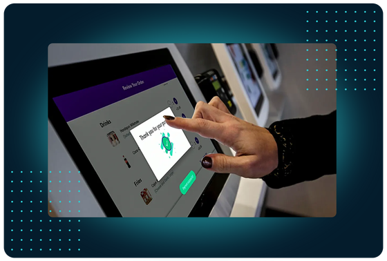 Customer tapping a FaciliPay self-service ordering kiosk to review an order and confirm a purchase.