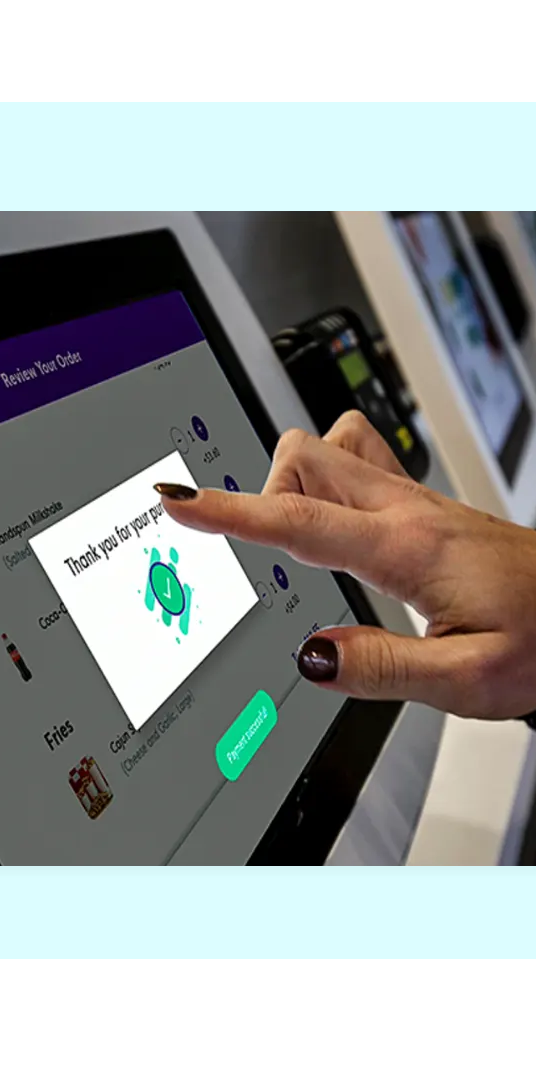 Customer tapping a FaciliPay self-service ordering kiosk to review an order and confirm a purchase.
