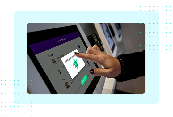 Customer tapping a FaciliPay self-service ordering kiosk to review an order and confirm a purchase.