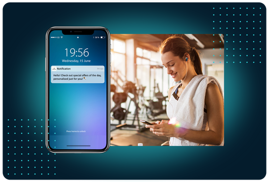 FaciliPay push notification with personalised offers on a phone lock screen, beside a woman at the gym.