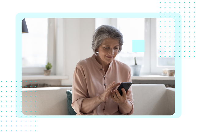 Older woman at home using her phone, representing FaciliPay payment solutions for healthcare and care settings.